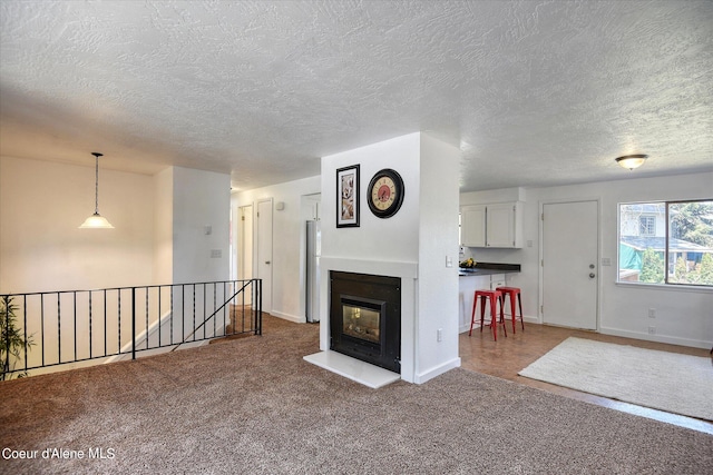 unfurnished living room with a textured ceiling and carpet floors