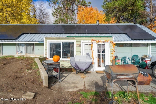 rear view of house featuring solar panels