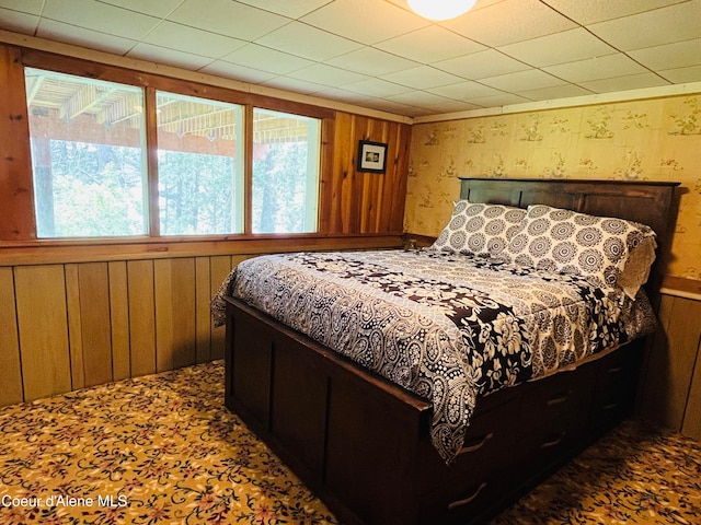 bedroom featuring wood walls