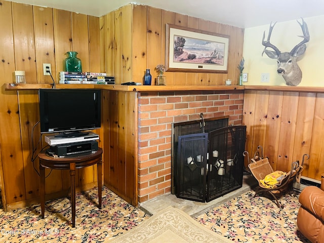 living room featuring wooden walls and a brick fireplace