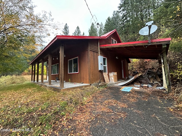 view of property exterior with a patio area