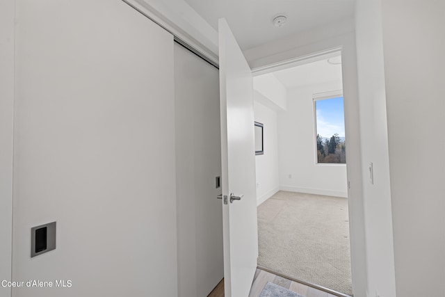 hallway with light wood-type flooring