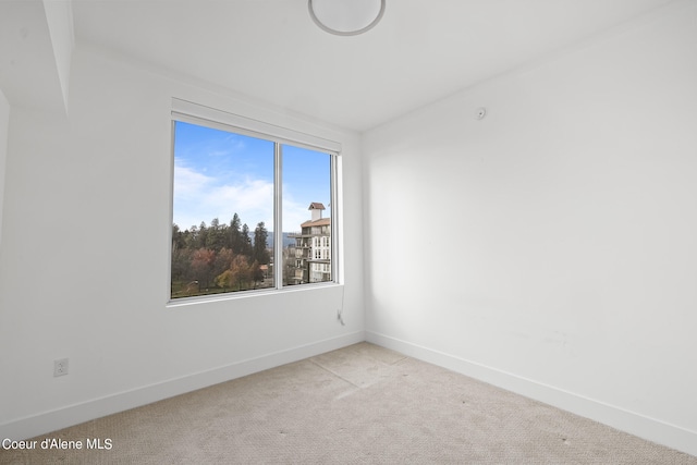 unfurnished room featuring light carpet