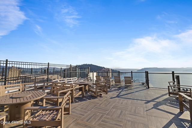 view of patio with a water and mountain view