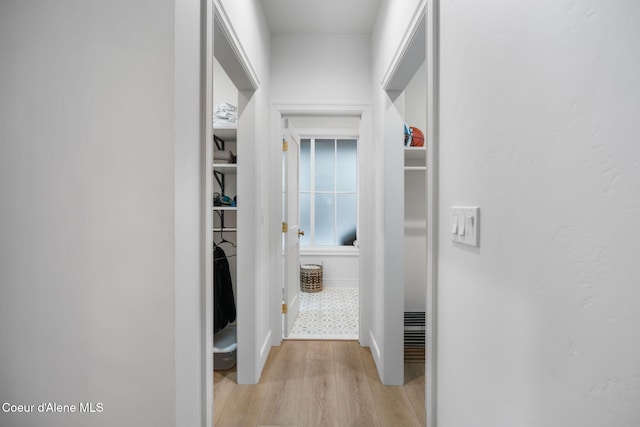 corridor with light hardwood / wood-style flooring