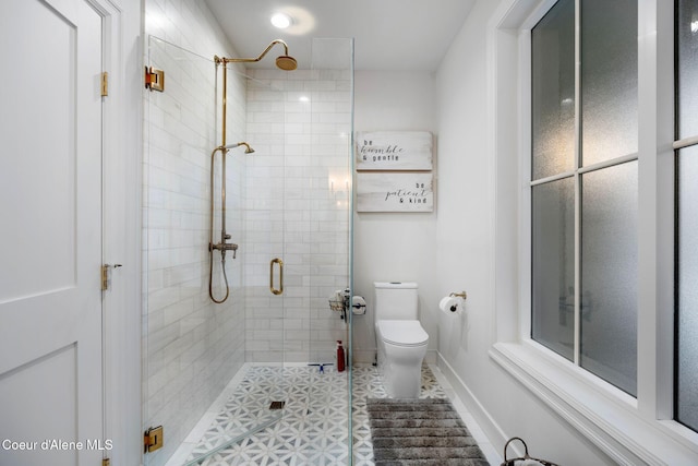 bathroom with tile patterned flooring, toilet, and walk in shower