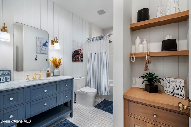 full bathroom featuring tile patterned floors, vanity, shower / tub combo, and toilet