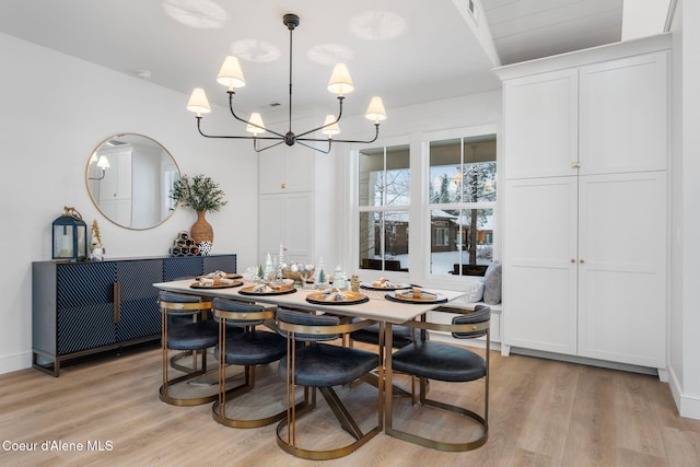 dining room with a notable chandelier and light hardwood / wood-style flooring