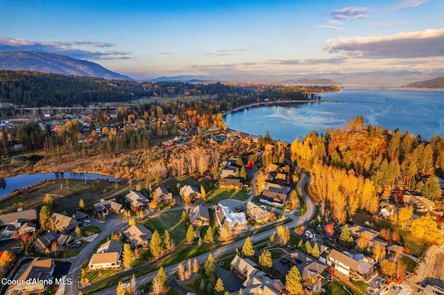 aerial view at dusk with a water and mountain view