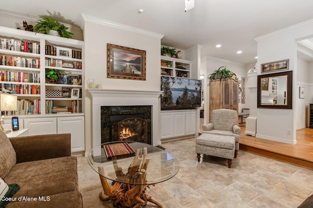 sitting room featuring a fireplace, light hardwood / wood-style floors, built in features, and ornamental molding