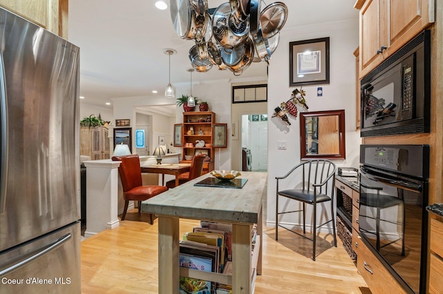 dining area featuring light hardwood / wood-style floors and ornamental molding