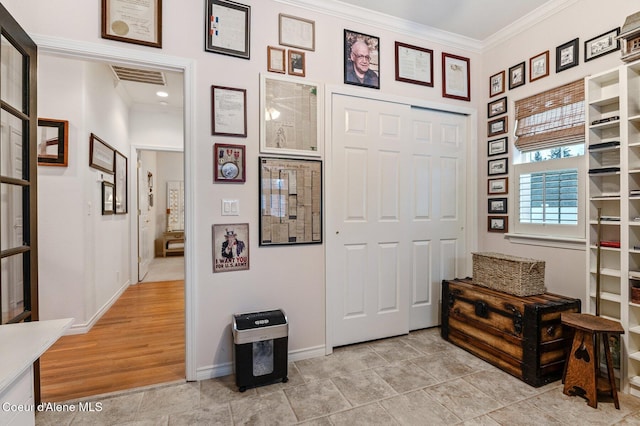 interior space with crown molding and light wood-type flooring