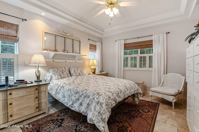 bedroom featuring a raised ceiling, multiple windows, ceiling fan, and crown molding