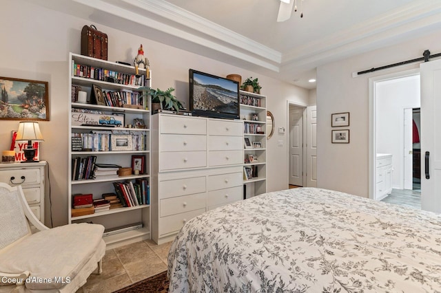 bedroom with ensuite bathroom, a raised ceiling, ceiling fan, crown molding, and a barn door