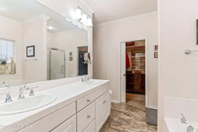 bathroom featuring vanity, ornamental molding, and independent shower and bath