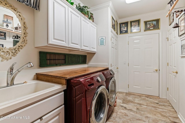 laundry room with cabinets, sink, washer and dryer, and ornamental molding