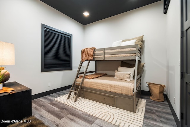 bedroom featuring baseboards and wood finished floors