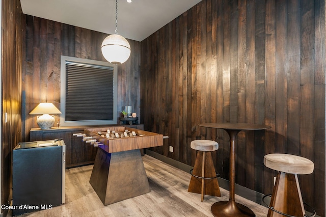 interior space featuring wooden walls and light wood finished floors