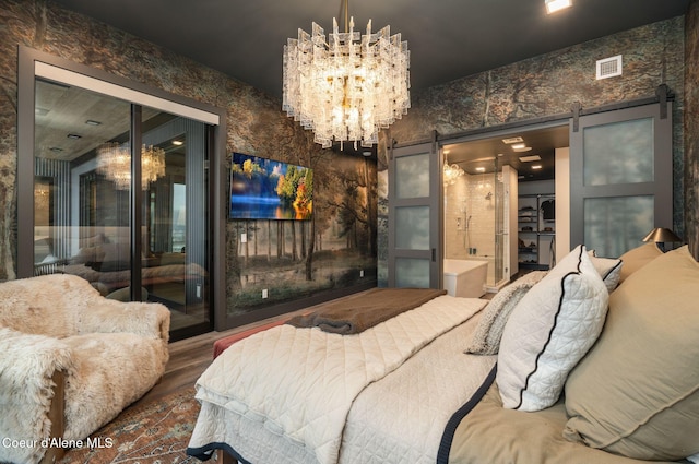 bedroom featuring a barn door, visible vents, access to outside, and a notable chandelier