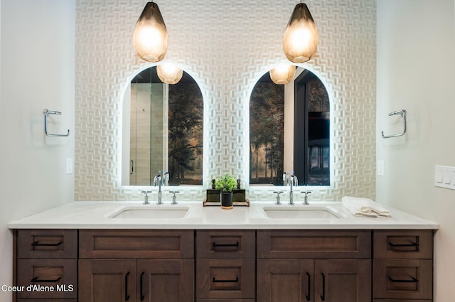full bath with a sink and double vanity