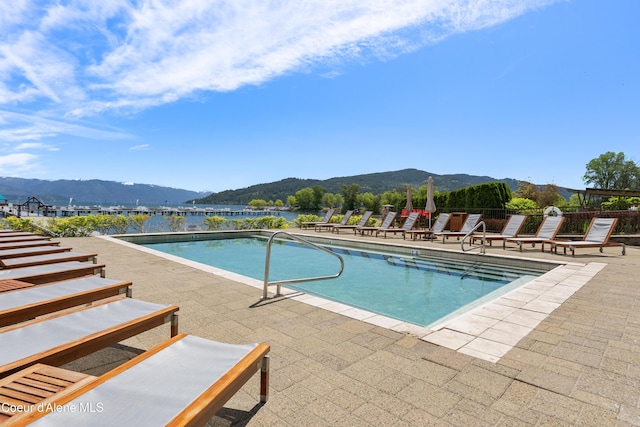 pool featuring a patio area and a mountain view
