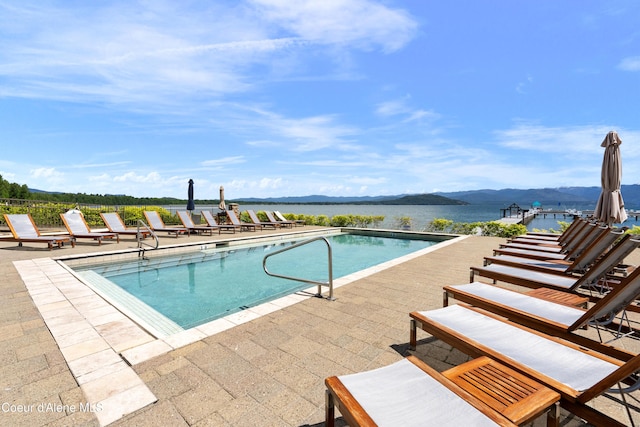 pool with a patio and a mountain view