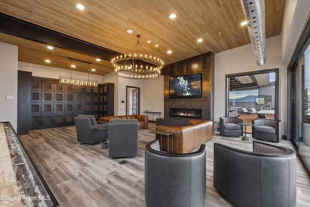 interior space featuring wooden ceiling, a fireplace, beamed ceiling, and wood finished floors