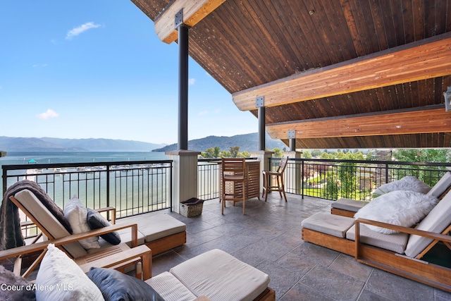 view of patio with a balcony and a mountain view