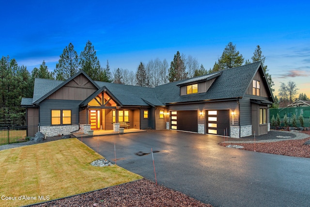 view of front facade with a yard and a garage