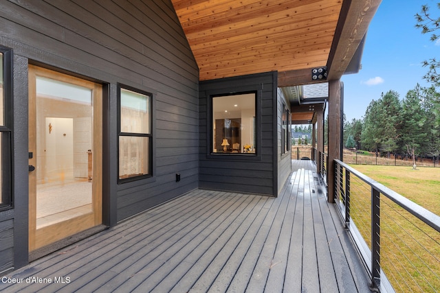 wooden terrace featuring a lawn