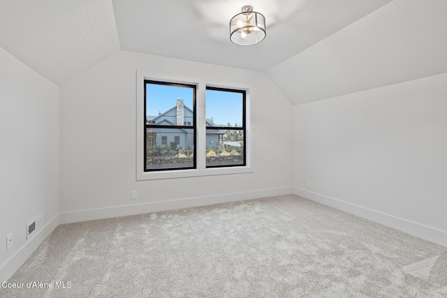 bonus room with light carpet and lofted ceiling