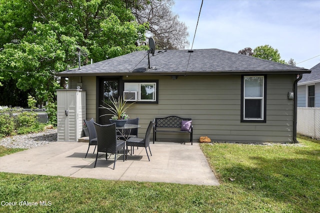 back of property featuring a patio and a lawn