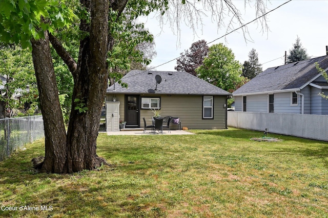 back of house with a patio area and a lawn