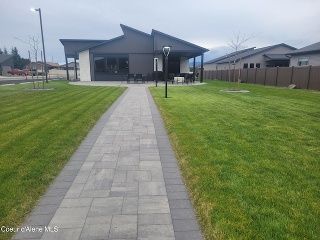 exterior space with a lawn and a patio