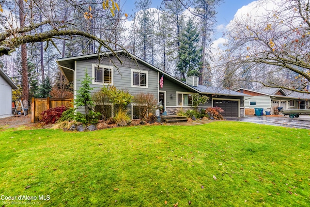 split level home featuring a front yard and a garage