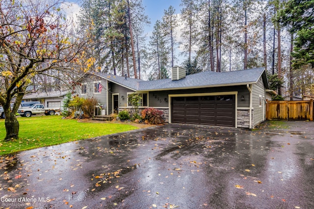 view of front of home with a front yard and a garage