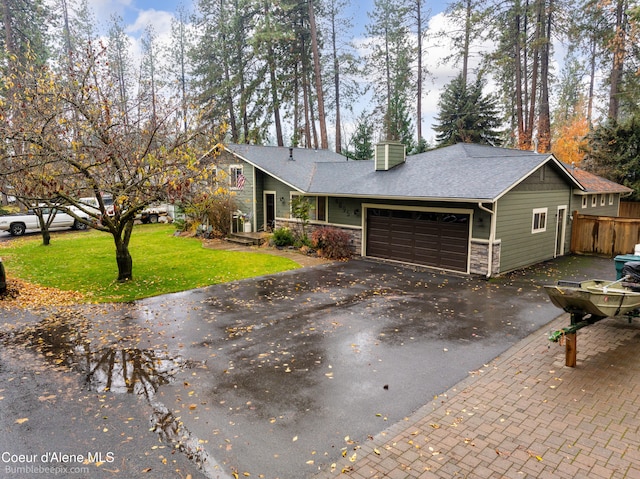 view of front of home with a garage and a front yard