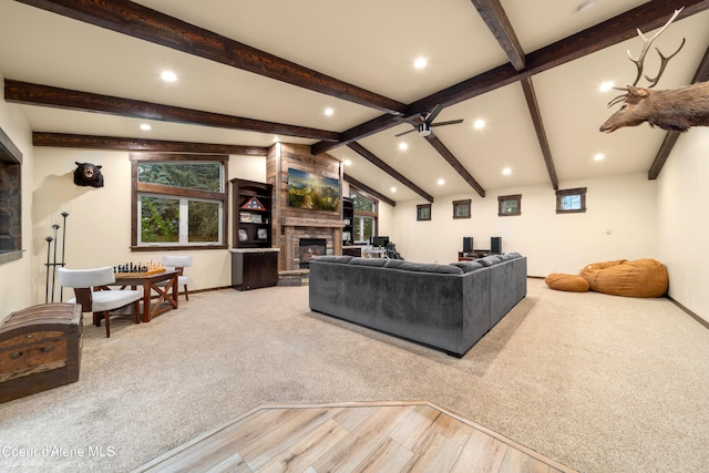 carpeted living room with lofted ceiling with beams and ceiling fan