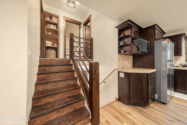 stairs featuring wood-type flooring