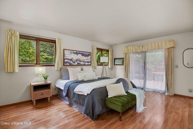 694 S Signal Point Rd, Post Falls, ID 83854 - bedroom with access to exterior, multiple windows, and light wood-type flooring