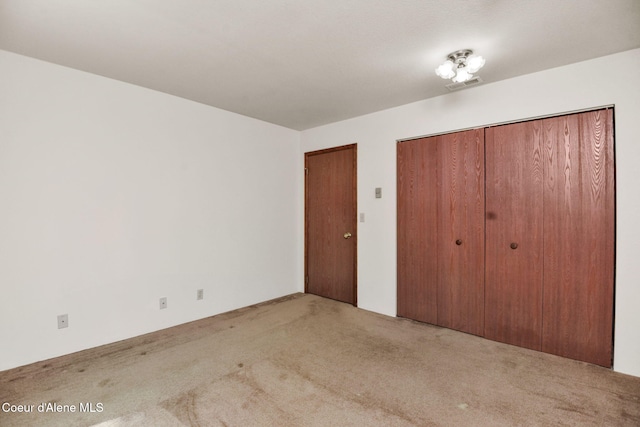 694 S Signal Point Rd, Post Falls, ID 83854 - unfurnished bedroom featuring carpet floors and a closet