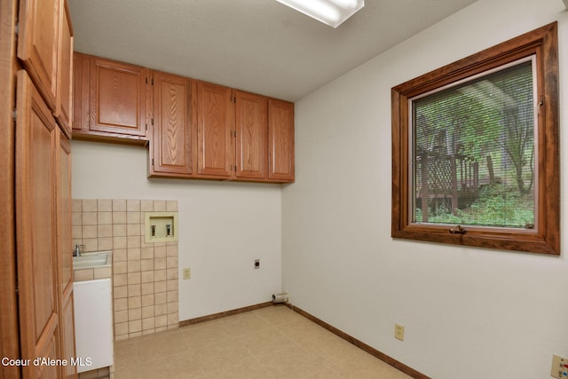 694 S Signal Point Rd, Post Falls, ID 83854 - washroom featuring hookup for an electric dryer, washer hookup, cabinet space, and tile walls