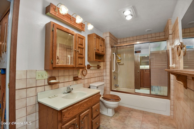 694 S Signal Point Rd, Post Falls, ID 83854 - bathroom featuring tile walls, enclosed tub / shower combo, and vanity