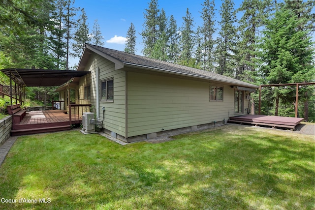 694 S Signal Point Rd, Post Falls, ID 83854 - view of home's exterior with a deck, a pergola, and a yard