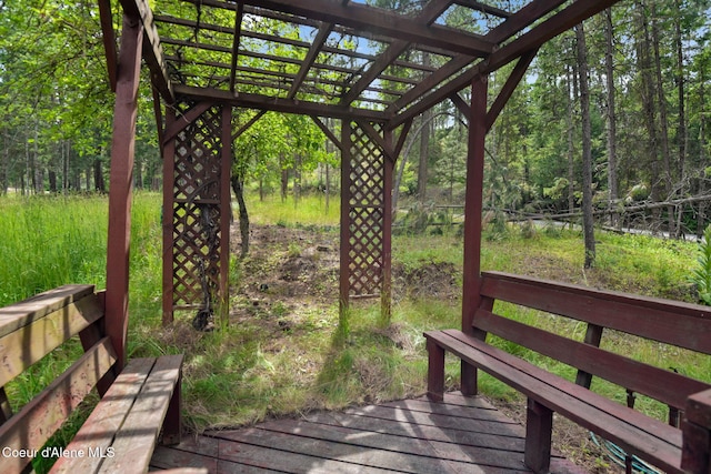 694 S Signal Point Rd, Post Falls, ID 83854 - wooden deck featuring a pergola and a wooded view