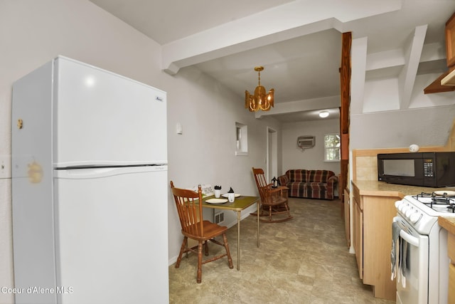 694 S Signal Point Rd, Post Falls, ID 83854 - kitchen featuring white appliances, a chandelier, light countertops, beam ceiling, and decorative light fixtures