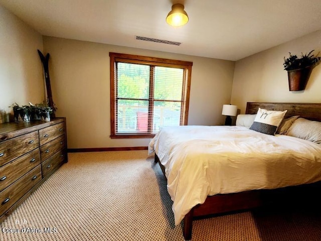 bedroom featuring light colored carpet