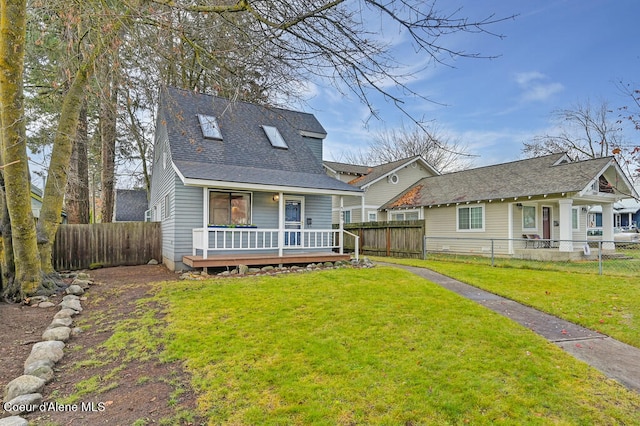 rear view of house with a yard and a wooden deck