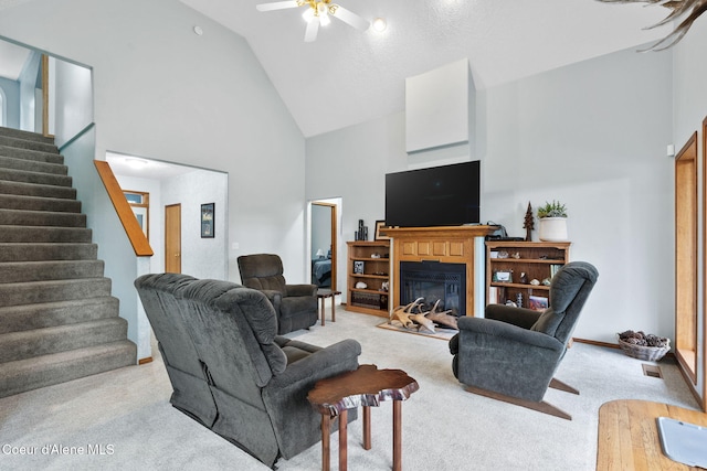 living room with light colored carpet, high vaulted ceiling, and ceiling fan