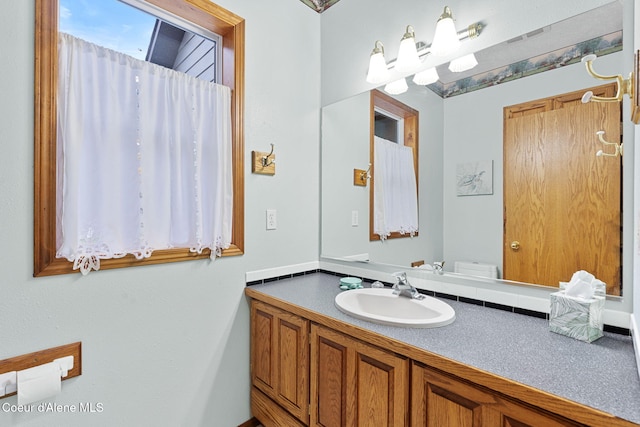 bathroom featuring vanity and toilet